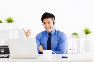 Smiling businessman wearing a headset at the office